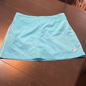 Nike blue women’s tennis skirt; size medium; white line down the side;